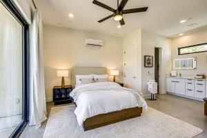 a bedroom with a bed and a ceiling fan at Luxury Desert Villa with Pool and Spa in Yucca Valley +23 photos
