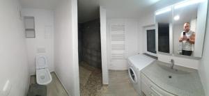 a man taking a picture of a bathroom with a mirror at U Studánky in Drnovec +23 photos