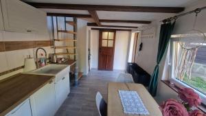 a kitchen and dining room with a table and a sink at U Studánky in Drnovec