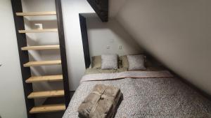 a small room with a bed in a attic at U Studánky in Drnovec