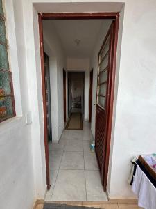 a hallway of a house with an open door at Casa Central Aconchegante in Cunha +2 photos