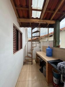 a room with a wooden table and a staircase in a building at Casa Central Aconchegante in Cunha
