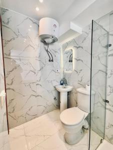 a bathroom with a toilet and a sink at Atlantis pirámides view Inn in Cairo +38 photos