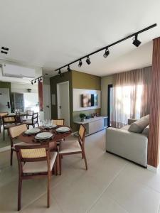 a living room with a table and a couch at Moov Smart Home – Studios e Apartamentos por Temporada em Cuiabá in Cuiabá