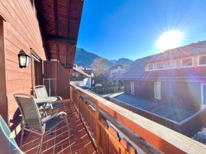 a balcony with a table and chairs on a building at Sonnenstüble in Oberstdorf