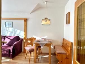 a dining room with a table and a chair at Sonnenstüble in Oberstdorf +10 photos