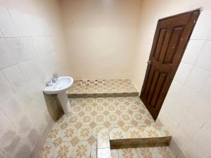 a small bathroom with a sink and a toilet at Brimelia Lodge in Bammbatuk +14 photos