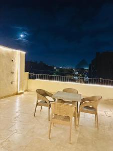 a table and chairs on top of a roof at Atlantis pirámides view Inn in Cairo