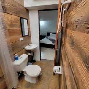 a bathroom with a toilet and a sink and a mirror at Viviendas Turísticas in Jericó +47 photos
