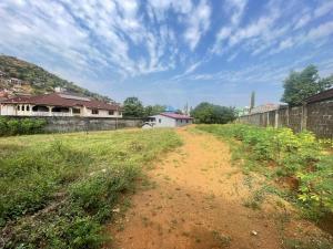 a dirt road in a field next to a building at Brimelia Lodge in Bammbatuk