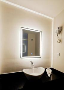 a bathroom with a sink and a mirror on the wall at Hotel Olimpica Boutique in Mexico City +30 photos