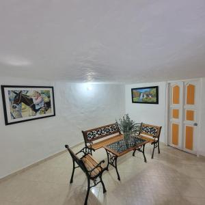 a dining room with a table and two chairs at Viviendas Turísticas in Jericó