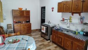 a kitchen with a sink and a stove top oven at Pousada da bancários in São Gabriel