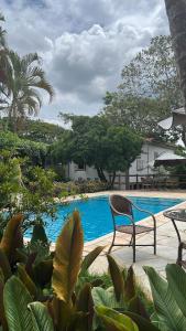 a chair sitting next to a swimming pool at Pousada Casagrande in Pirenópolis