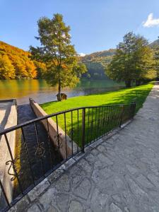a metal fence next to a body of water at TOKIs apartmani in Mrkonjić Grad