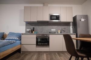 a kitchen with a sink and a stove top oven at Penzion Na výminku in Veselí nad Moravou