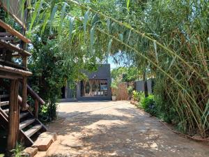 a walkway leading to a building with a tree at Bolt in Gaborone