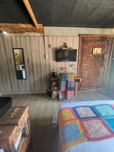 a bedroom with a bed and a tv in a room at Bolt in Gaborone