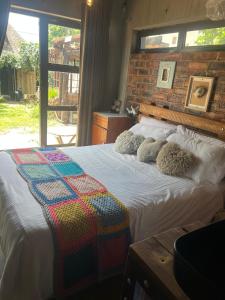 a bedroom with a bed with stuffed animals on it at Bolt in Gaborone