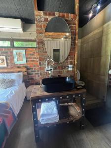 a bathroom with a sink on a table with a mirror at Bolt in Gaborone +23 photos