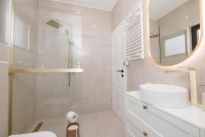 a white bathroom with a sink and a mirror at De Villa Bey in Kupres +16 photos