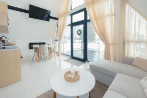 a living room with a couch and a table at De Villa Bey in Kupres