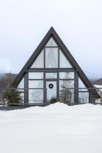 a large glass building in the snow at De Villa Bey in Kupres