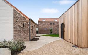 a courtyard between two brick buildings with a doorway at De Kompanie in Alken