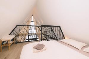 a bedroom with a white bed and a window at De Villa Bey in Kupres