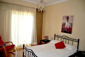 a bedroom with a bed and a chandelier at Maria's House in Kavala