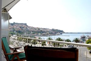 a balcony with a view of a body of water at Maria's House in Kavala