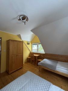a bedroom with a bed and a table in it at Ośrodek Nad Potokiem in Poręba Wielka