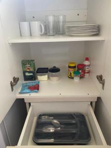 a kitchen with a stove and other food items on shelves at My Place in Encarnación