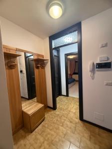 a room with a hallway with two doors and a phone at Chalet Nonno Ezio in Valdidentro