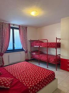 a bedroom with two bunk beds and a window at Chalet Nonno Ezio in Valdidentro +5 photos