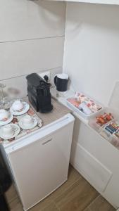 a small kitchen with a counter with plates and dishes at Dimora Garibaldi Apartment & Room in Agrigento