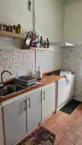 a kitchen with white cabinets and a sink at Hostel Varas in Viña del Mar