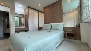 a bedroom with a large bed in a room at Amazon Condo, Building B, ground floor with direct pool access in Jomtien Beach +20 photos