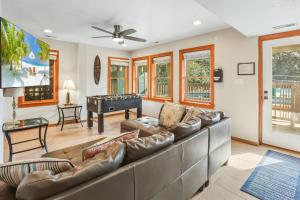 a living room with a couch and a pool table at 2070 - Sol Mates in Duck