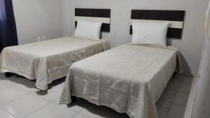 two beds sitting next to each other in a room at HOTEL TAMPICO EXPRESS MORALILLO in Tampico +7 photos