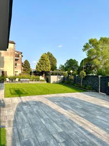 a patio with a grass yard and a building at Willa Dominik in Jastarnia
