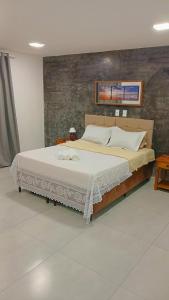 a bedroom with a large bed in a room at Pousada Litorânea in Saquarema