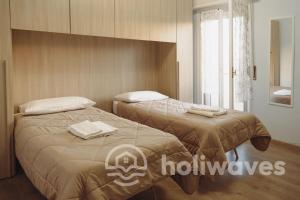 a bedroom with two beds with towels on them at La casa di Luisa in Moneglia