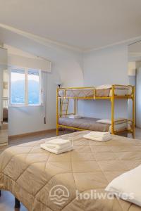 a bedroom with two bunk beds and a window at La casa di Luisa in Moneglia