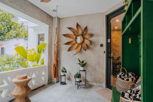 a hallway with a door and a clock on the wall at Flor De India in San Juan +84 photos