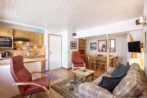 a living room with a couch and a table at Résidence Igloo in Chamonix +9 photos