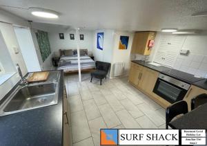 a kitchen with a sink and a bed in a room at Beckington House in Braunton
