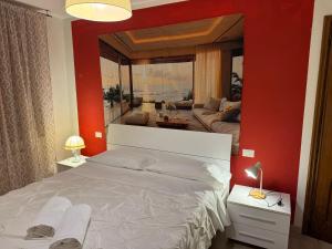 a bedroom with a large mirror above a bed at Sun Moon Venice Harrysclass in Venice