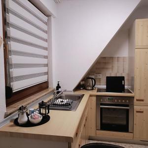 a kitchen with a sink and a stove at Urban Apple in Bad Mergentheim +14 photos