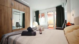 a bedroom with a bed with a stuffed animal on it at Les Arts in Valencia